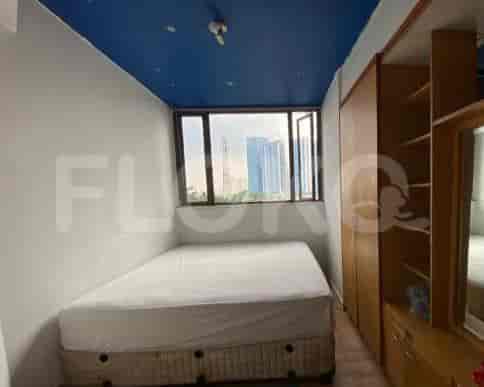 A small bedroom featuring a bed, window, and closet.