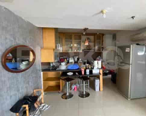A kitchen with wooden cabinets, a bar counter, and appliances.