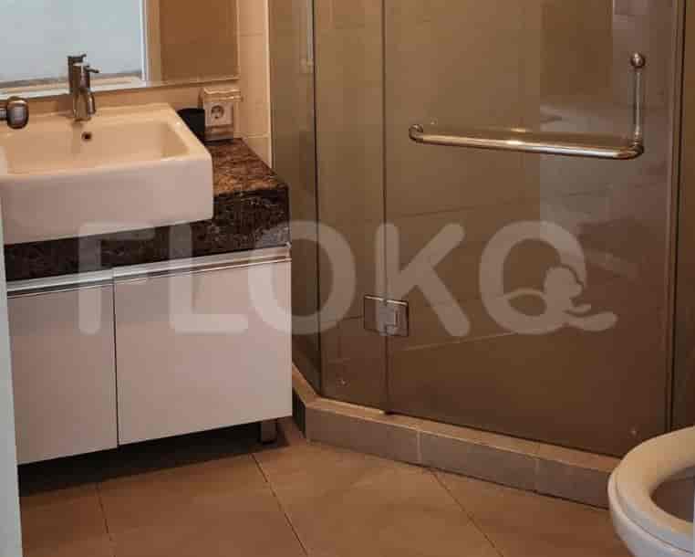 Modern bathroom with a shower, sink, and toilet.
