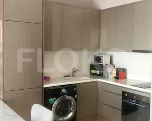 Modern kitchen with built-in appliances and ample storage.