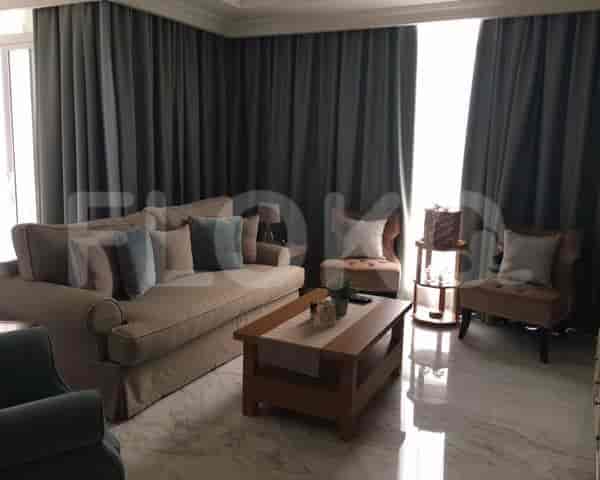 A living room with a sofa, armchairs, and a coffee table.