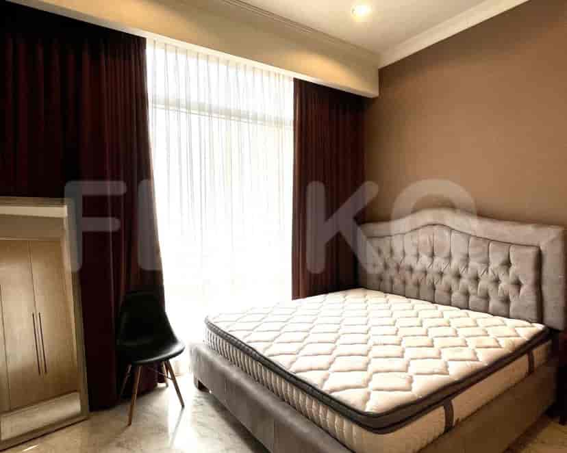 A bedroom with a queen-sized bed, dark brown curtains, and a simple design.
