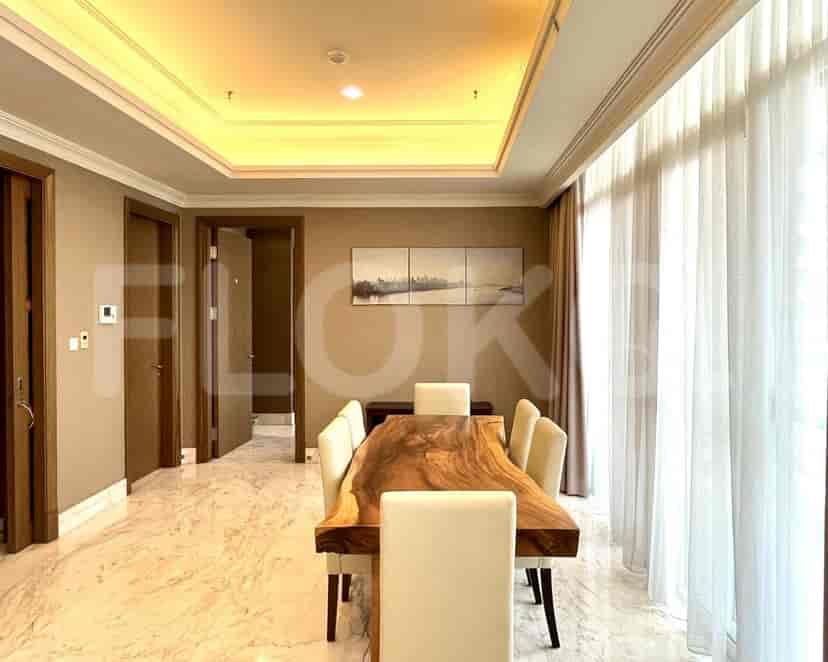 A dining room with a wooden table, marble flooring, and neutral walls.