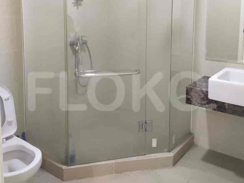 A bathroom with a glass shower enclosure and a modern sink.