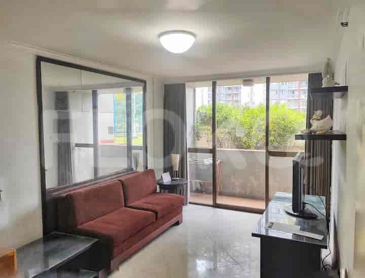 Cozy living room with a maroon sofa, large mirror, and access to a balcony.