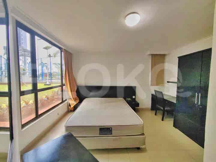 Spacious master bedroom with a double bed, desk, and view of the park.