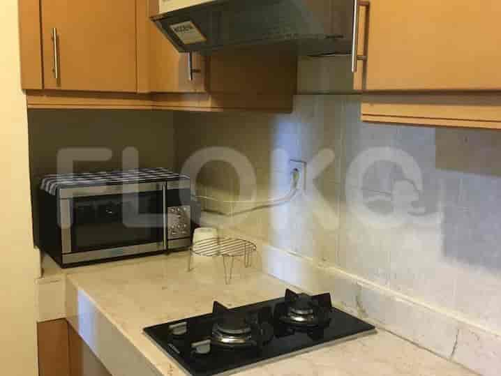 Kitchen with gas stove, microwave, and cabinets.