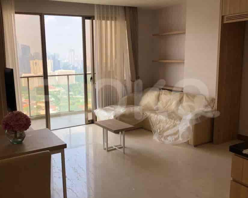 Living area with a sofa, table, and city view.