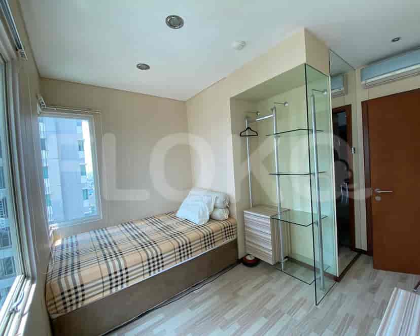 Small bedroom with single bed and a glass-enclosed wardrobe.