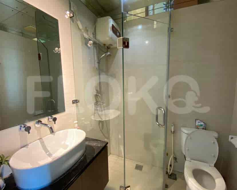 Modern bathroom with a shower, sink, and toilet.