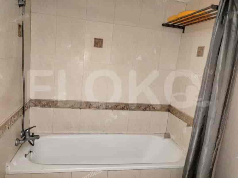 Bathroom with a bathtub and tiled walls.