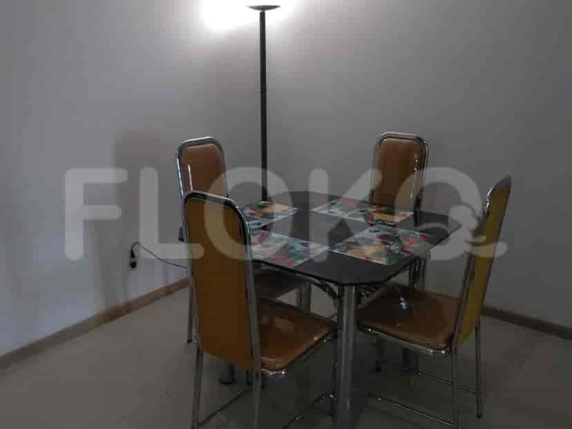 A dining area with a table and chairs.