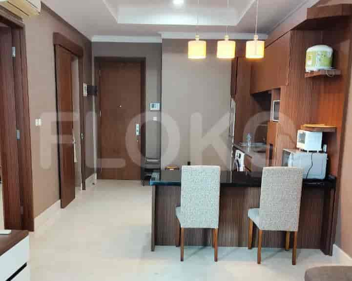 Kitchen and dining area with a breakfast bar and chairs.