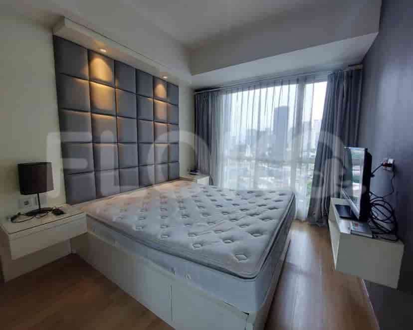 A well-lit bedroom with a king-size bed, large window, and night curtains.