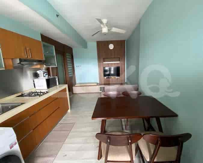 Kitchen and dining area with wooden cabinets, a gas stove, and a dining table.