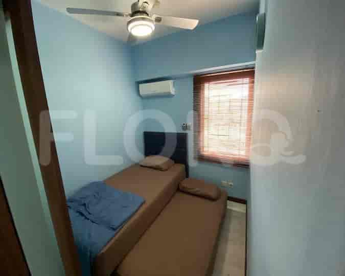 Bedroom with twin beds and air conditioning.