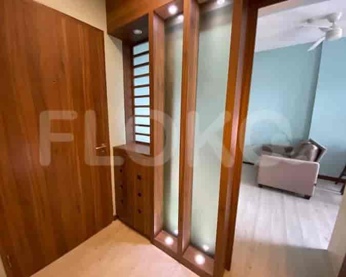 Entrance area showing wooden door and built-in decor.