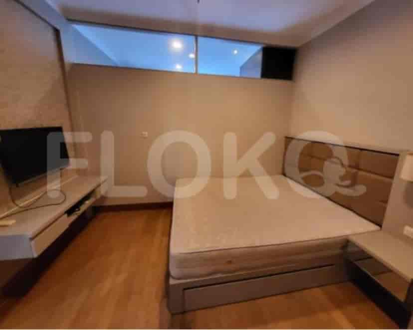 A modern bedroom with a double bed, wooden flooring, and a neutral color palette.