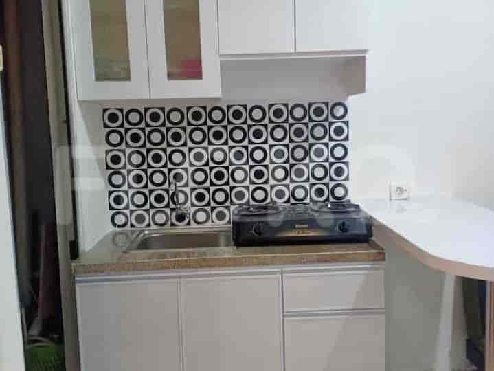 Kitchen with stove, sink and cabinetry