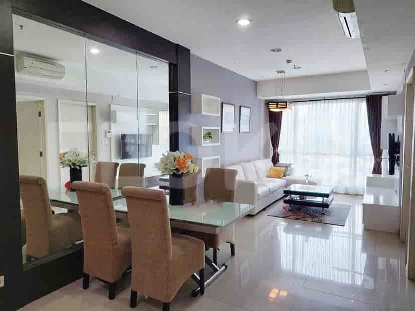 Spacious living and dining area with a large mirror and modern furniture.