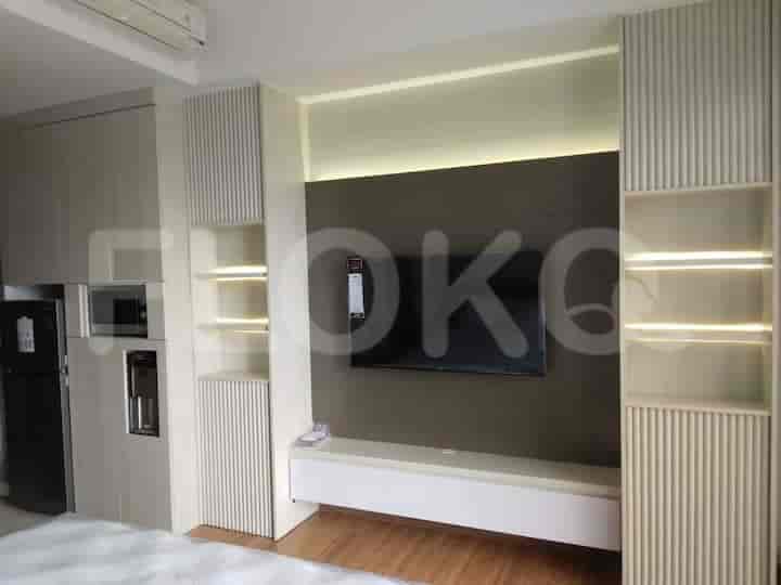 A living area with a built-in entertainment center and a TV.