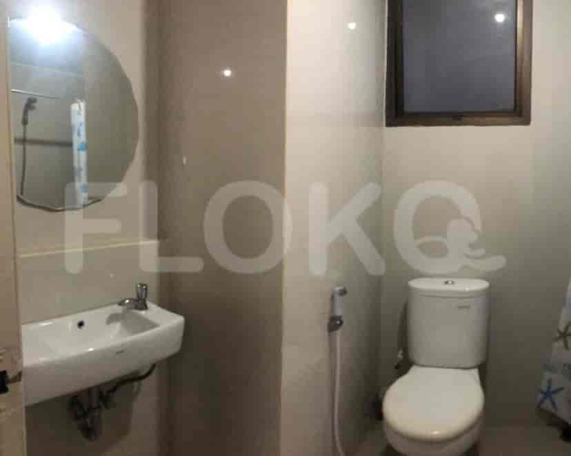 Bathroom with a sink, toilet, and a mirror.