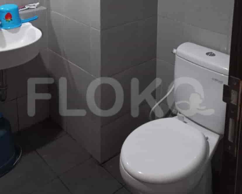 A small bathroom featuring a toilet and a sink.