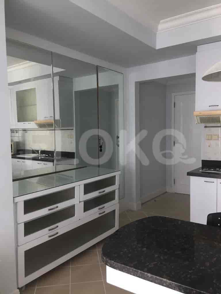 Kitchen area with cabinets and a bar.