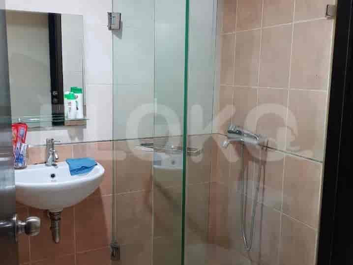 A bathroom with a sink, mirror, and shower.