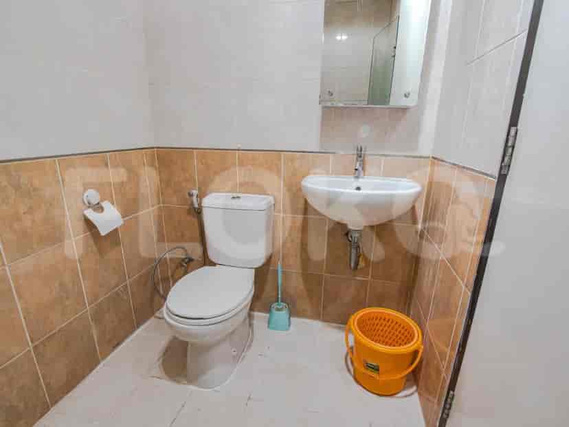 Bathroom with a toilet, sink, and shower.