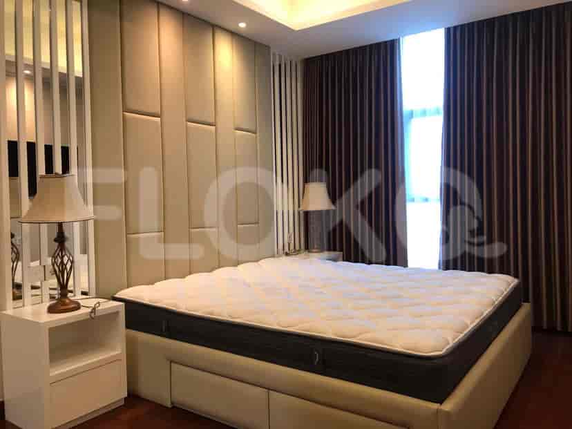 Elegant bedroom with a king-sized bed, bedside tables, and a floor-to-ceiling window.