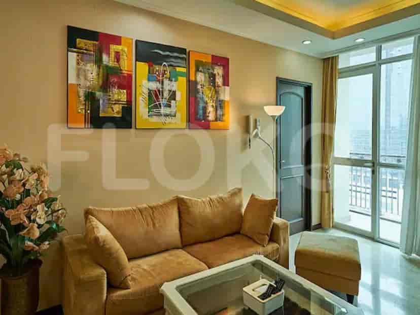 Living room with abstract art and a tan sofa.