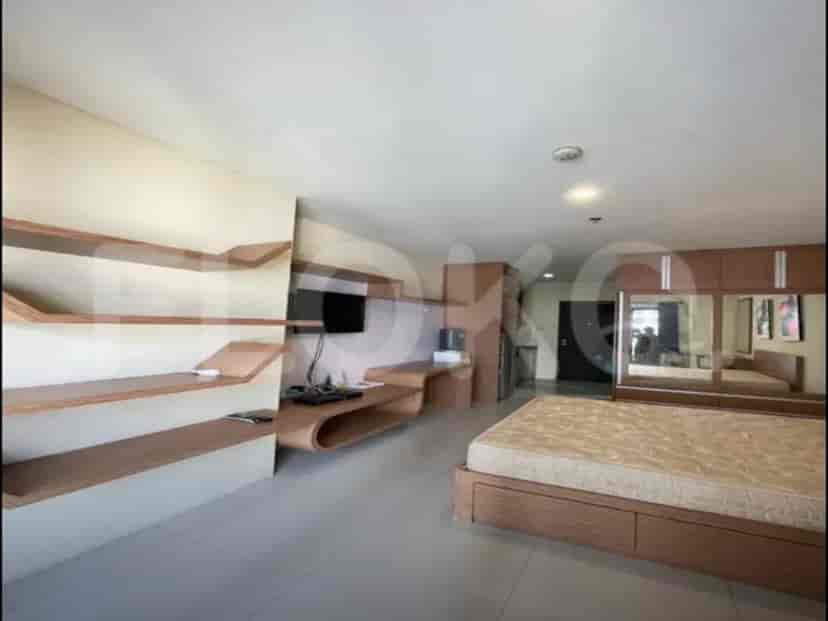 A bedroom with a bed, shelves, and a mirror closet.