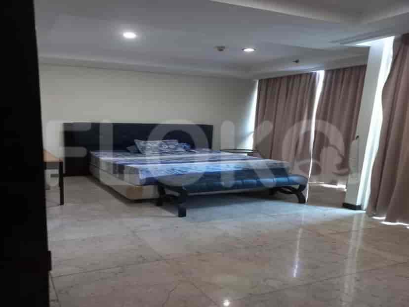 Bedroom featuring a bed with a headboard, side table and marble flooring.