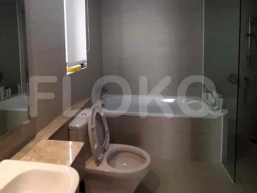 A bathroom with a bathtub, toilet, and sink.