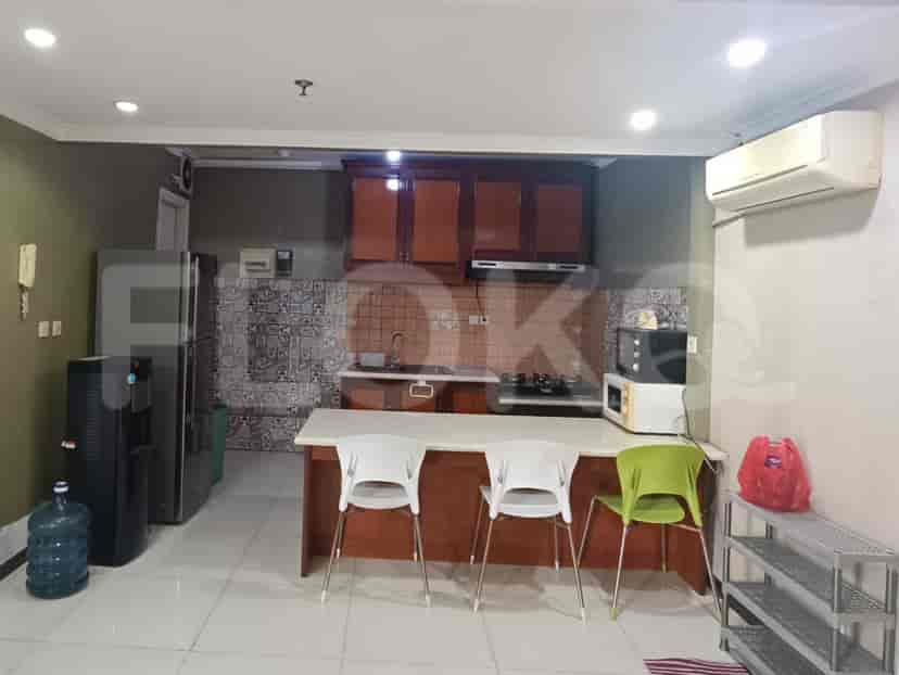 A modern kitchen with wooden cabinets and white countertops.