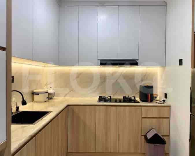 Modern kitchen with light wood and white cabinetry.