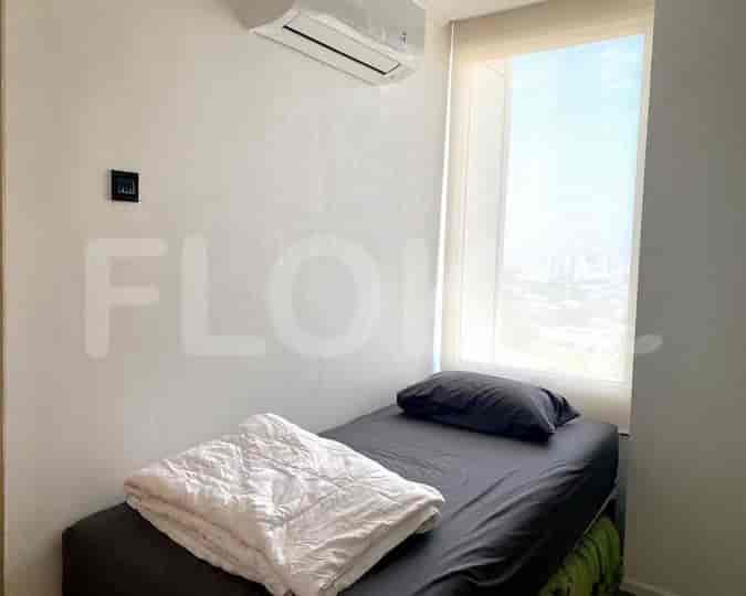 Small bedroom with a single bed and air conditioner.
