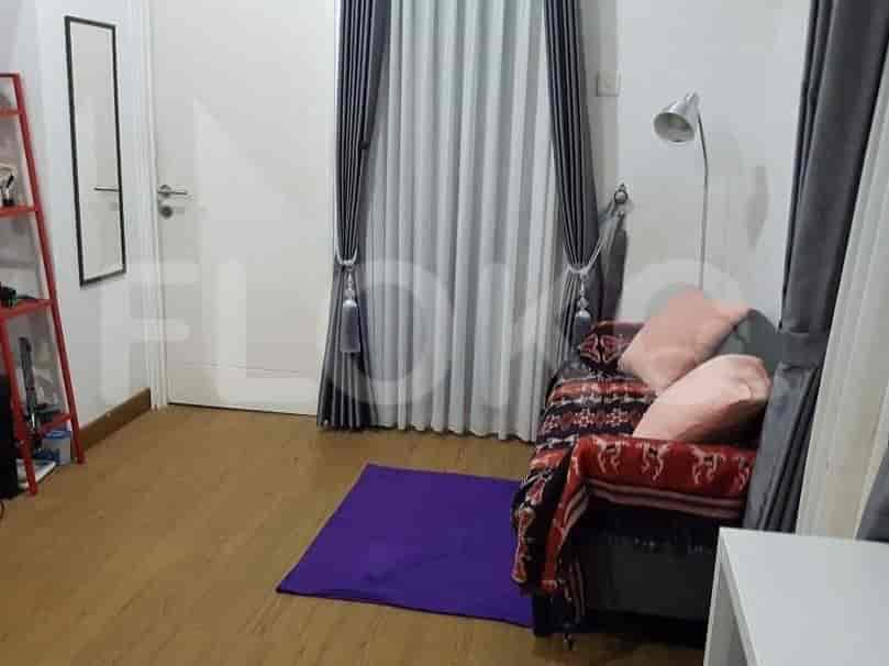 A cozy bedroom featuring a small bed, curtains, and a rug.