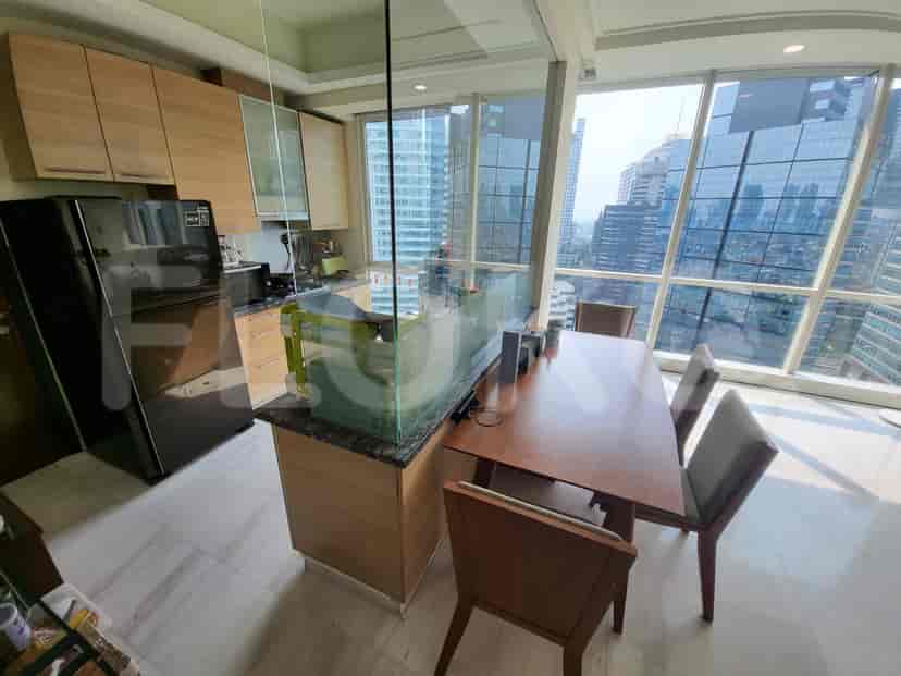 A well-lit kitchen with city views and a dining area.