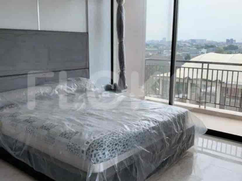 Bedroom with bed, window and city view.