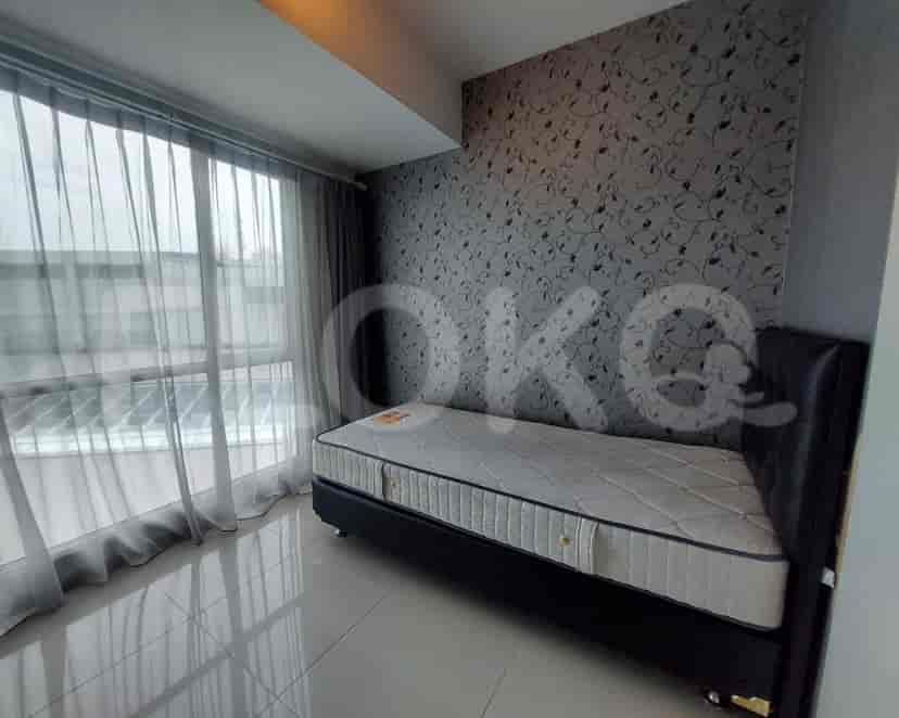 Modern bedroom with a single bed and patterned wallpaper.