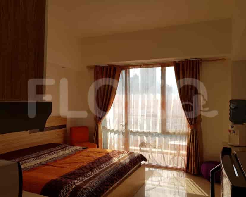 Bedroom with large windows and city view.