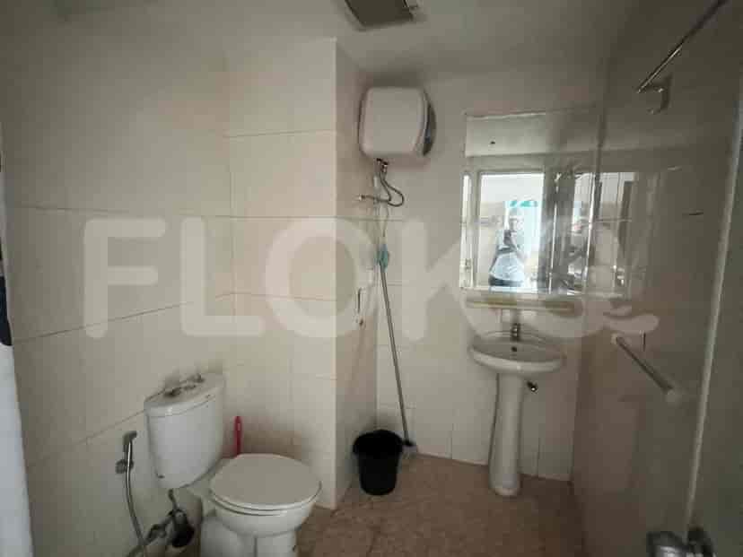 Simple bathroom with basic fixtures and a mirror.