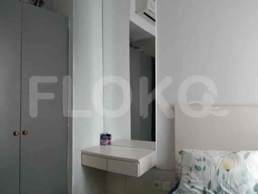 Bedroom with a bed, a dressing table, and a closet.