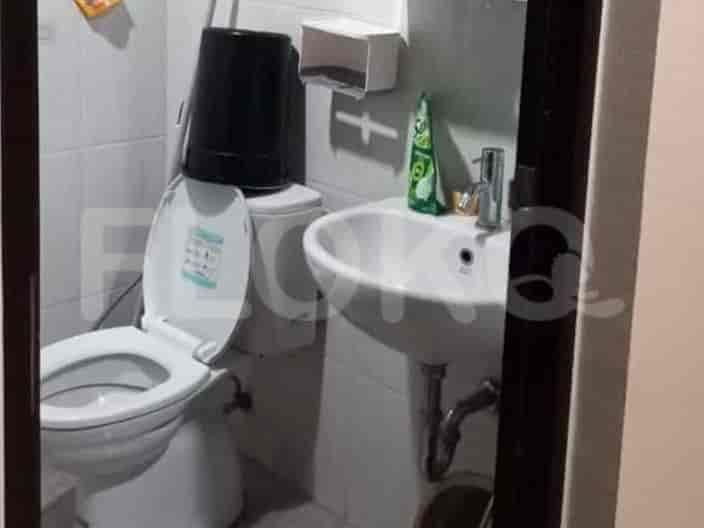 A small bathroom with a toilet, sink, and basic fixtures.