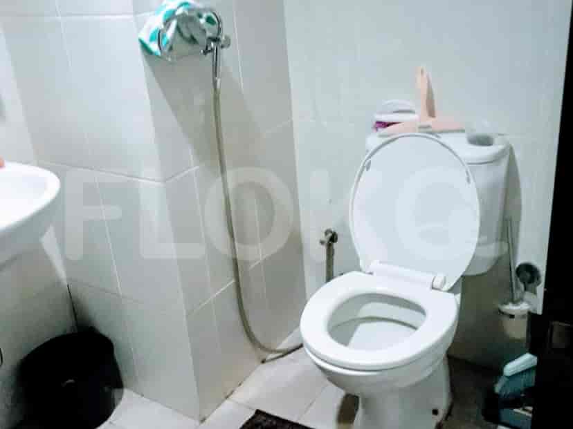 A bathroom with a toilet, sink, and shower.
