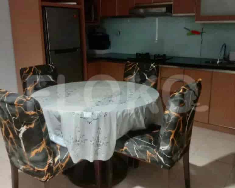 A dining area with a round table and four chairs.