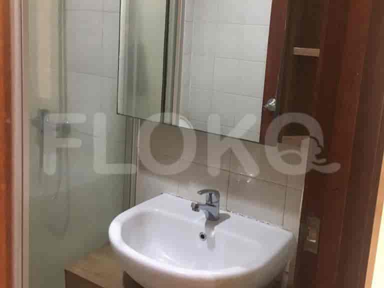 A small bathroom featuring a sink and shower.