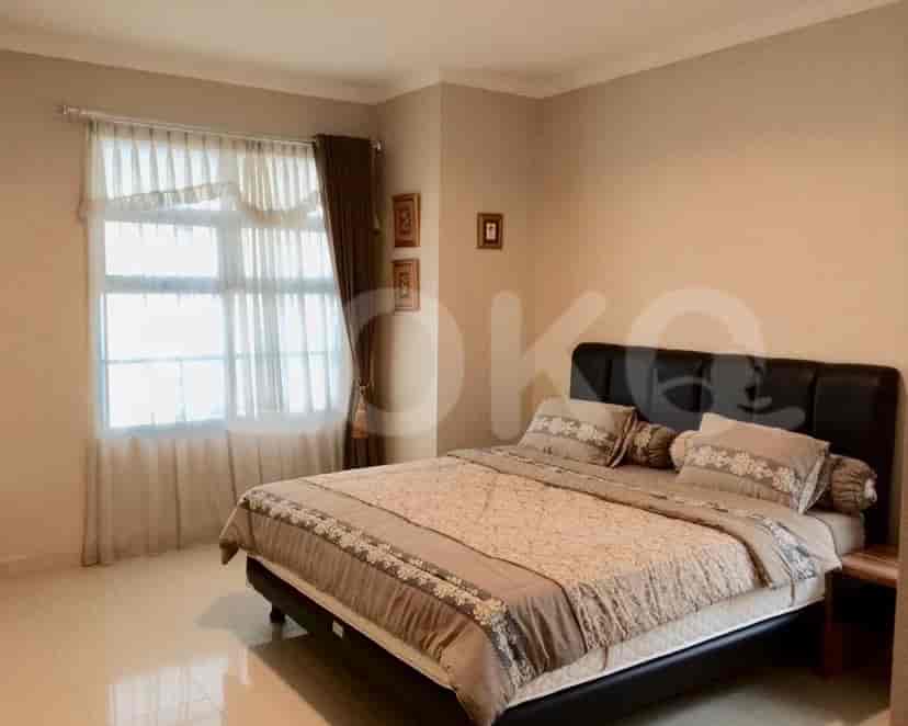 Bedroom with a double bed, framed pictures, and a window.